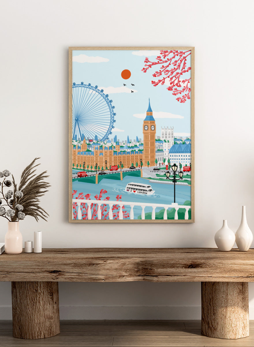 A colorful illustrated cityscape of London featuring Big Ben, the London Eye, red double-decker buses, a river boat, clouds, birds, and pink blossoms against a light blue sky. Shop Spring London Landmarks by Nidhi Kachhadiya, a colorful London wall art print featuring Big Ben, the London Eye, cherry blossoms, and bright spring city views.
