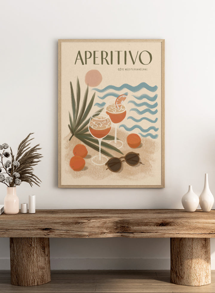 A travel-style poster reading “APERITIVO” with “CÓTE MEDITERRANÉENNE” beneath it, showing illustrated cocktails, citrus fruits, palm leaves, blue ocean waves, and sunglasses on a warm beige background.Aperitivo Beach Day by Katarzyna Gąsiorowska Mediterranean art print featuring spritz cocktails, oranges, sunglasses, and vintage coastal style.