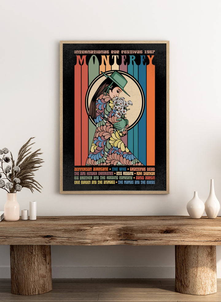 A retro-style concert poster for the 1967 European Tour featuring the band Monterey. The design has a black background with vertical multicolored stripes in orange, green, blue, and beige, surrounding an illustration of a woman in a green hat and patterned dress holding white flowers. Flower Child Festival by Retrodrome retro music art print inspired by the 1967 Monterey Pop Festival, with flower-child imagery and vintage concert poster style.