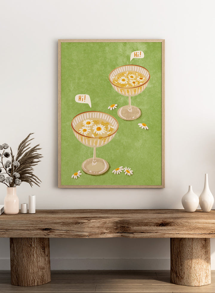Illustration of two cocktail glasses with daisies on a green background. Hi by Raissa Oltmanns is a modern cocktail art print featuring smiling daisy drinks in playful contemporary wall poster style.