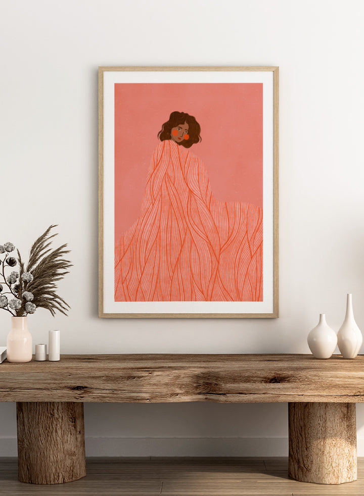 An art print featuring an illustration of a woman with dark curly hair wrapped in a flowing coral-orange patterned dress against a solid pink background. Coral Woman Dreaming by Bea Müller portrait art print featuring a woman wrapped in a flowing coral dress with fine red lines and modern graphic detail.