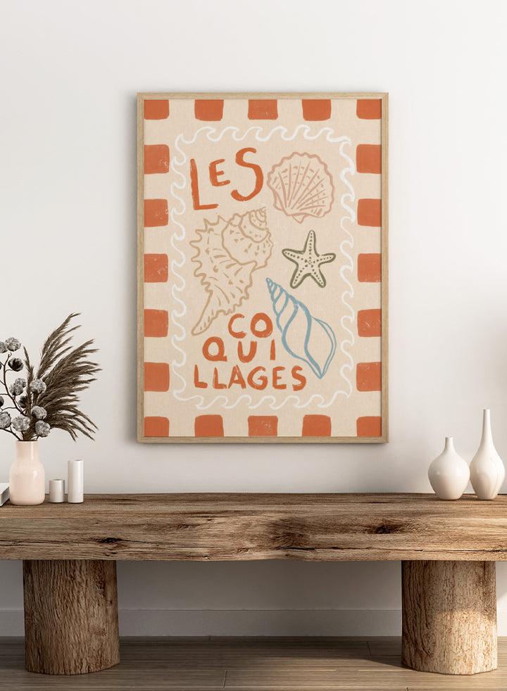 A square decorative print or card with the French text “LES COQUILLAGES” in orange lettering, surrounded by illustrated seashells and a starfish on a cream background with an orange-and-white check border. Rustic French Seashells by Katarzyna Gąsiorowska coastal art print with hand-drawn shells, a starfish, French lettering, and terracotta checks.