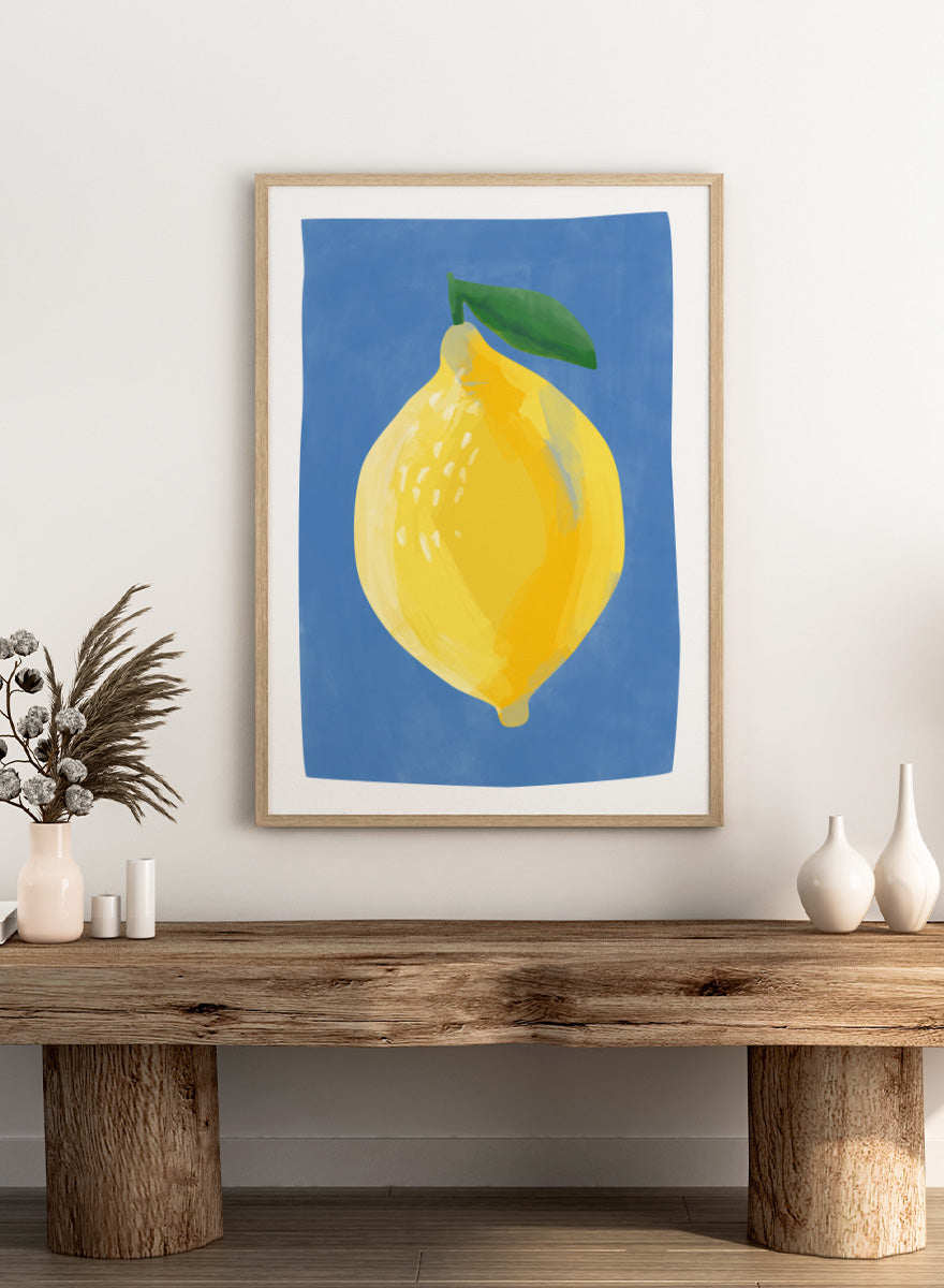Shop Bright Yellow Lemon by Elena Ristova, a colorful lemon wall art print poster featuring an oversized yellow fruit, green leaf, and vivid blue background.