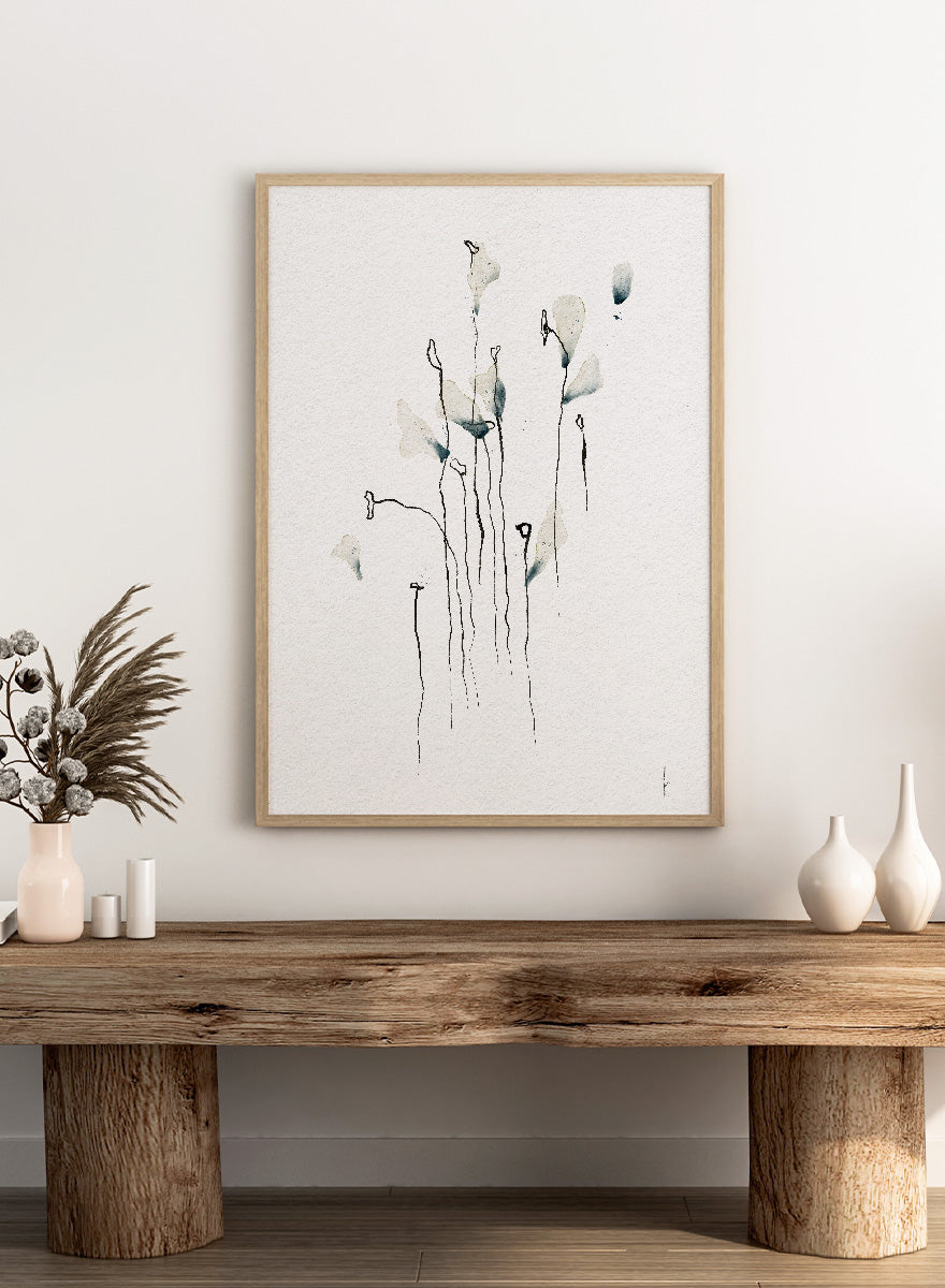 Minimalist watercolor floral art print featuring delicate calla lily-like stems and leaves in soft gray-green and black on textured white paper. Shop Delicate Abstract Flowers by Ankie Kooi, a modern floral wall art print poster with minimalist line art, abstract botanicals, soft blue, and green tones.
