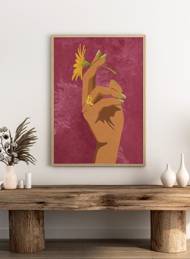 Illustration of a hand holding a yellow flower against a pink background. Smoking Flower by Raissa Oltmanns is a modern floral art print featuring a hand holding a yellow flower in bold contemporary wall poster style.