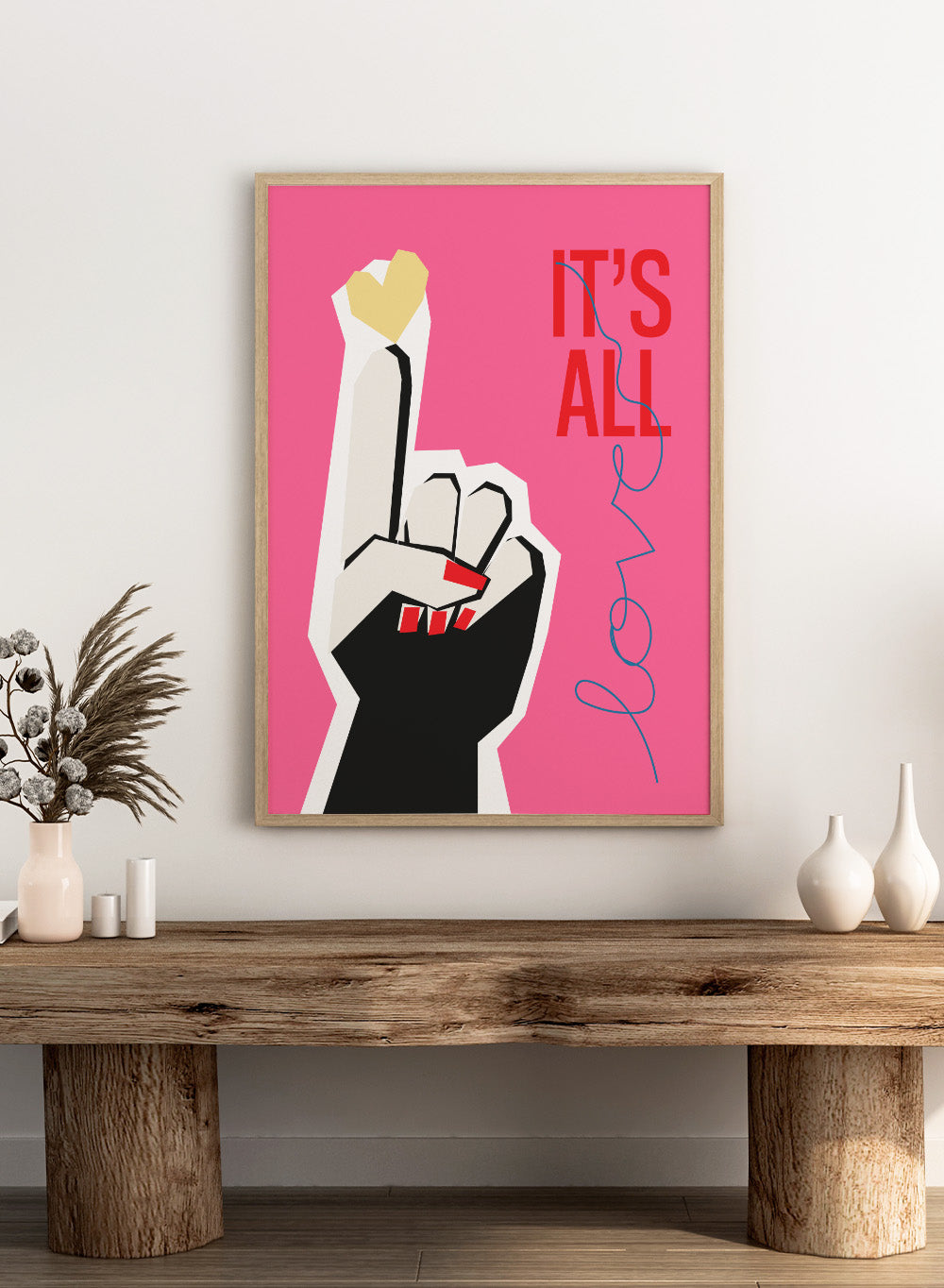 Illustration of a hand making a peace sign with text 'IT'S ALL LOVE' on a pink background. It’s All Love Hand Pink by Frances Collett is a modern graphic art print featuring an illustrated hand with heart symbol and bold typography. Officially licensed wall poster with optional framing.
