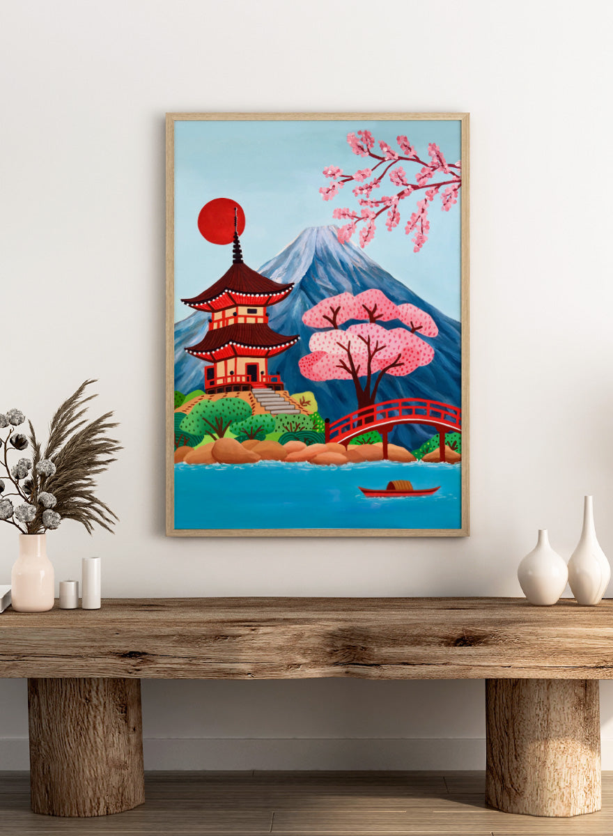 A colorful Japanese-style landscape artwork showing a red pagoda beside a red bridge over blue water, with pink cherry blossoms, a mountain, and a red sun in the sky. Shop Japanese Pagoda Spring Landscape by Nidhi Kachhadiya, a colorful Japan travel wall art print featuring Mount Fuji, cherry blossoms, a red pagoda, and spring scenery.