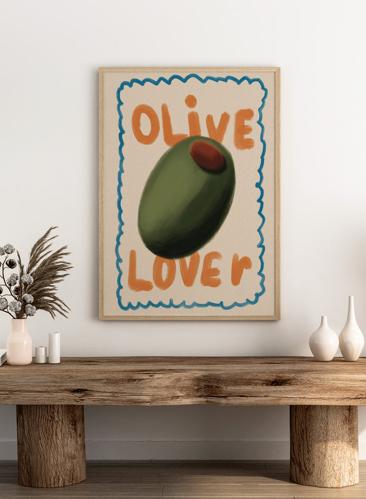 An art print featuring a stylized illustration of an olive with the words &