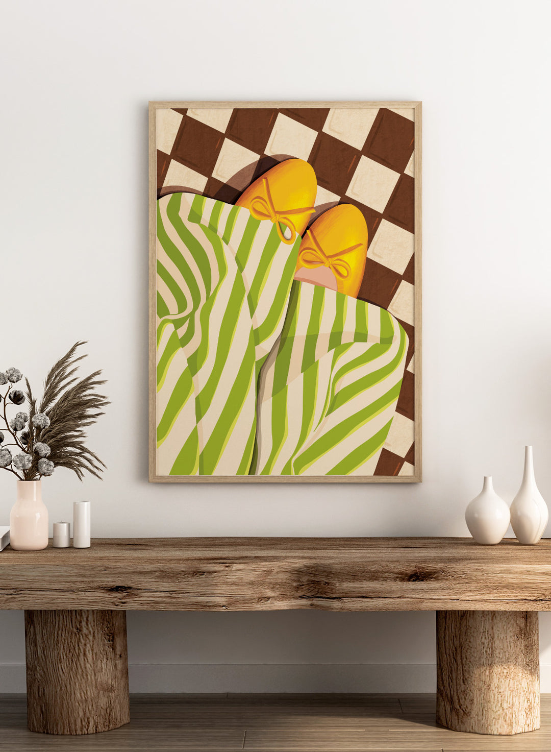 A stylized illustration of a person wearing green and white striped pajama pants and yellow slip-on shoes with bow details, lying on a brown and cream checkered floor. Cozy Striped Feet by Lisa Solomoniuk premium framed fine art print featuring yellow slippers, green striped trousers, and a bold checkered floor.