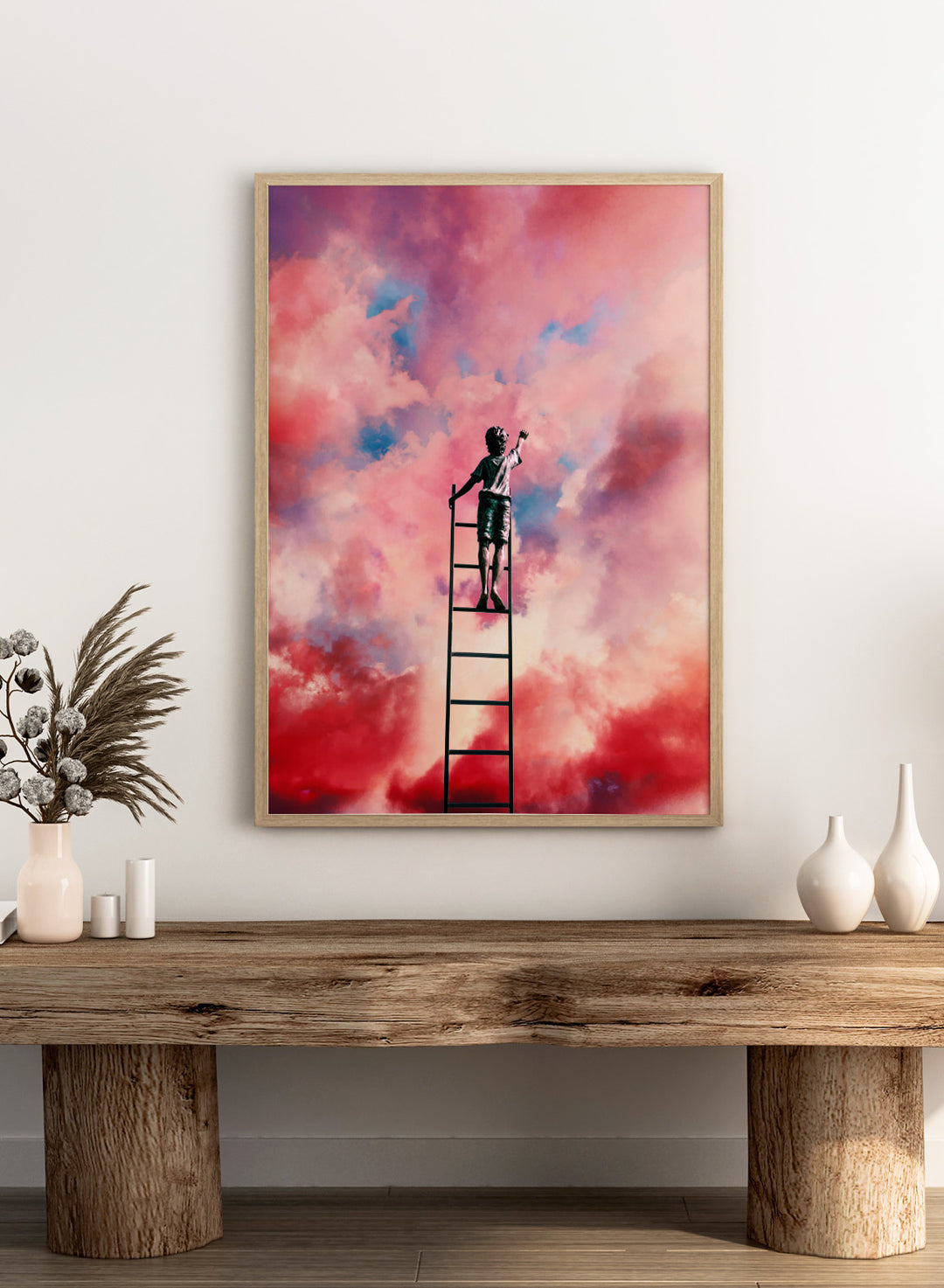 Person standing on a ladder against a colorful cloud sky. Cloud Painter by Taudalpoi surreal ladder to sky art print with pink clouds and dreamlike cosmic atmosphere, retro inspired collage poster wall art.