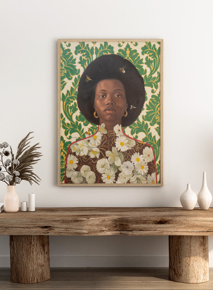 A stylized portrait artwork of a Black woman with an afro hairstyle, wearing gold hoop earrings and a brown top covered in white daisy flowers, set against a green and cream damask patterned background with small bees visible. Shop Afro Floral Portrait by Damilare Jamiu, a contemporary portrait wall art print featuring a woman with afro hair, floral details, bees, and rich green tones.