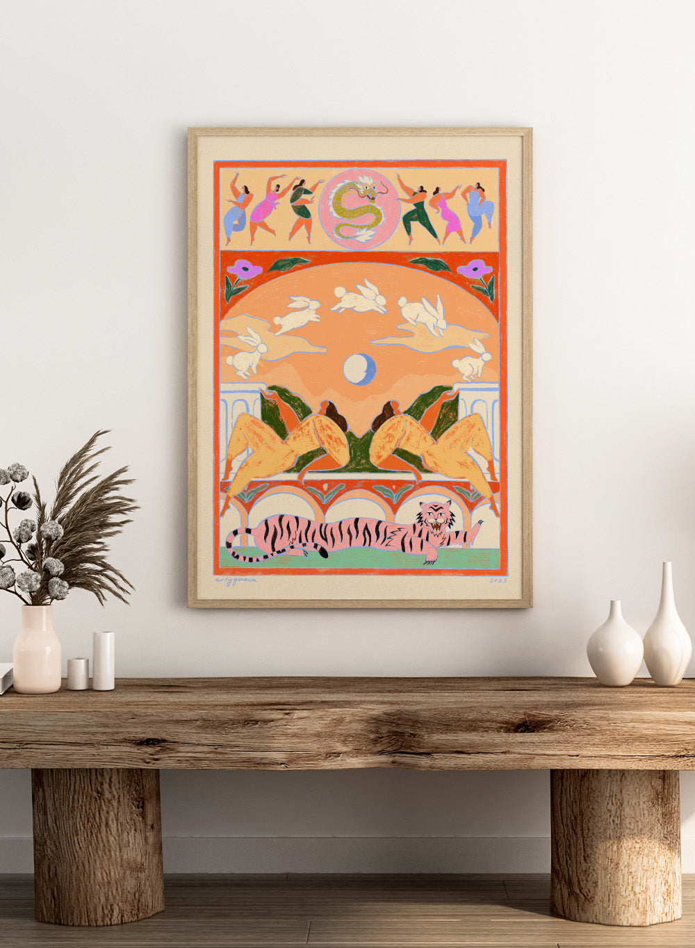 Decorative artwork with animals and people in a stylized setting. Rabbit Jumps Over the Moon by Arty Guava is a surreal art print with rabbits, dancers, and a tiger in bold color. Officially licensed wall poster.