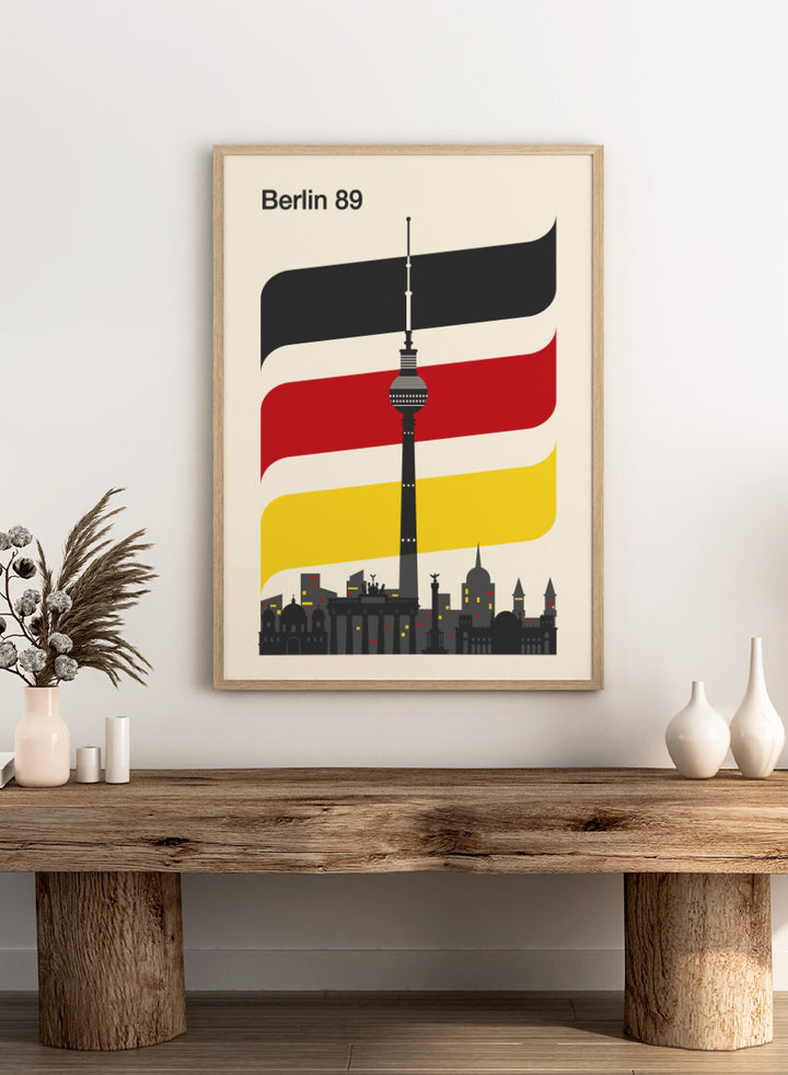 A minimalist travel poster for Berlin 1989, featuring the Fernsehturm TV tower and city skyline against a cream background, with stylized German flag stripes in black, white, red, and yellow. Berlin 89 German Skyline by Retrodrome travel art print featuring the Fernsehturm, Berlin skyline, German flag colors, and bold retro poster design.