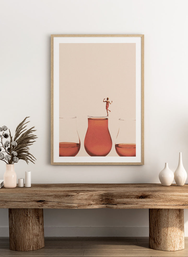 I Prefer the Full One by Maarten Léon collage art print featuring a woman standing on a full glass. Premium fine art print with real wood framing.