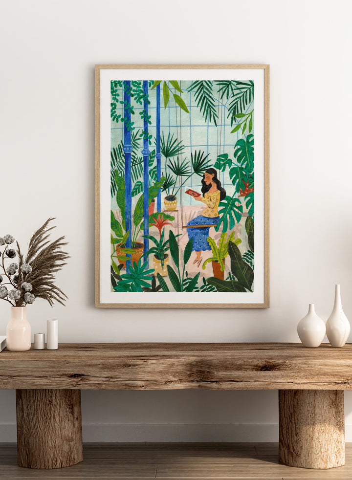 Woman sitting among plants in a room with bamboo and various greenery. Botanical Greenhouse Reader by Caroline Bonne Müller is a fine art print and wall poster featuring a woman reading in a lush indoor garden filled with tropical plants.