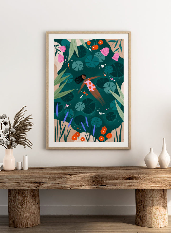 Shop Woman Floating Lily Pond by Bea Müller, a figurative wall art print poster featuring a woman floating among lily pads, flowers, and colorful fish in deep green water.