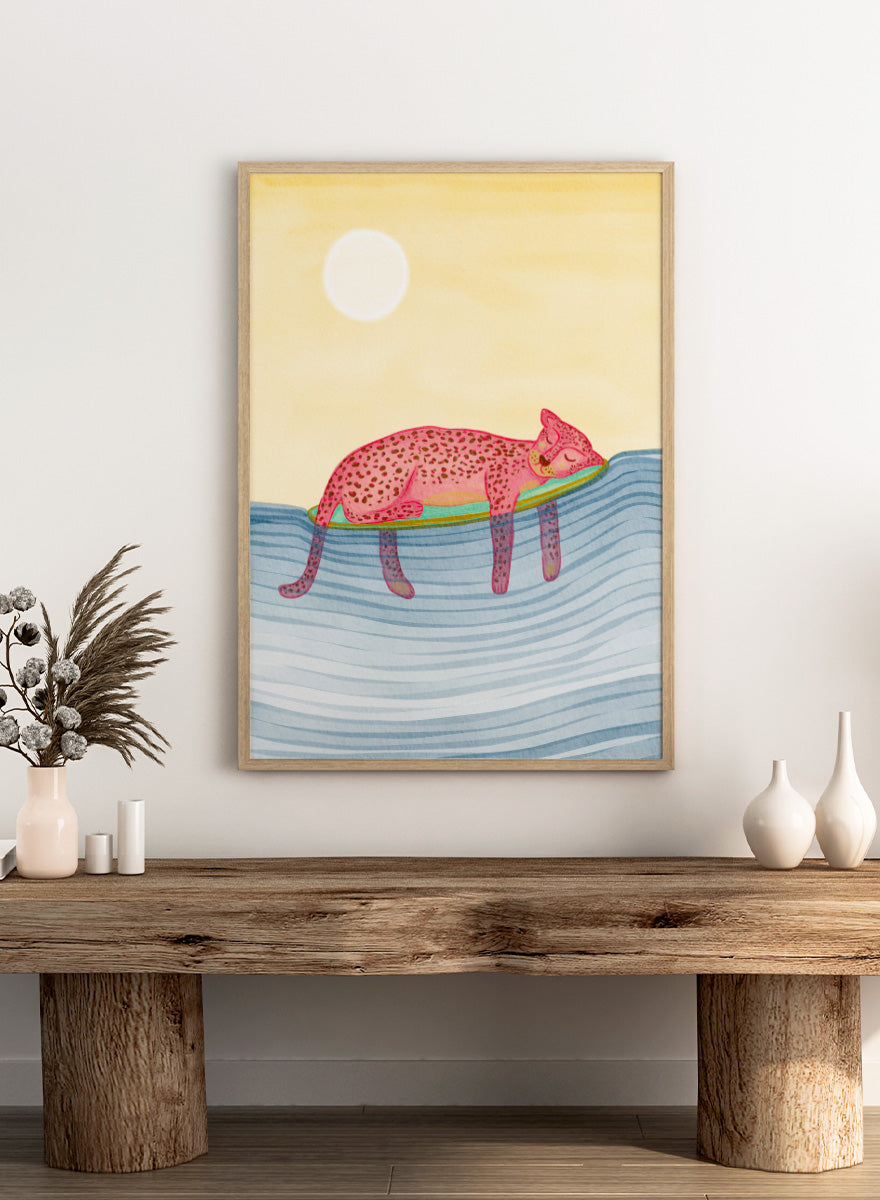 Shop Dreamy Leopard Float by Nikita Jariwala, a playful animal wall art print poster featuring a pink leopard relaxing on a pool float in blue water.