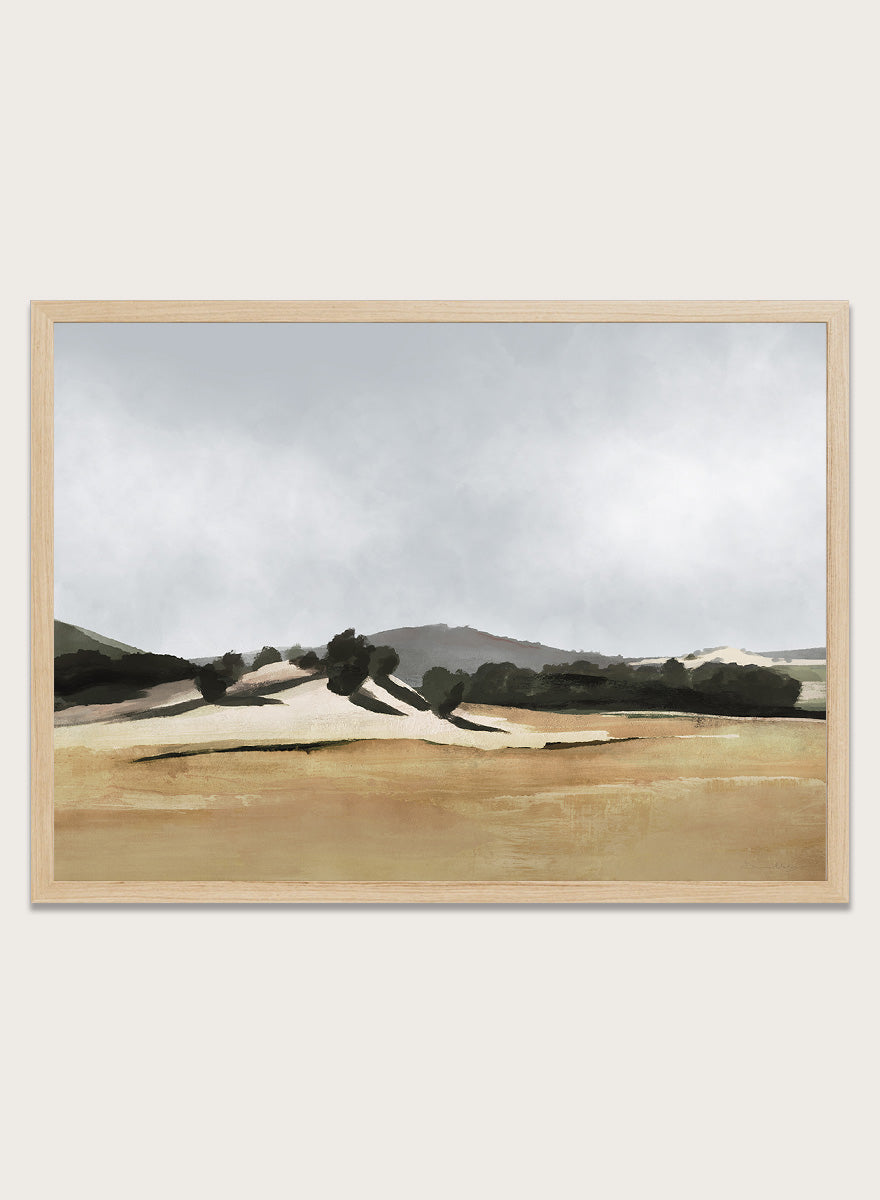 Shop Lazy Afternoon by Dan Hobday, a warm landscape art print featuring golden fields, dark trees, rolling hills, and soft late-summer tones.