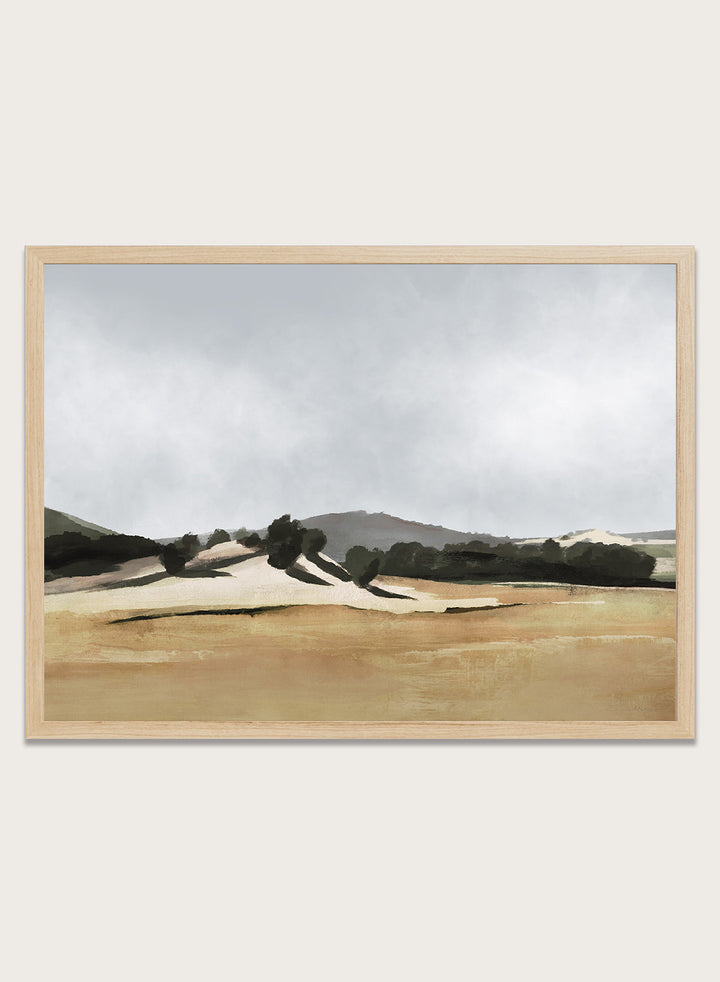 Shop Lazy Afternoon by Dan Hobday, a warm landscape art print featuring golden fields, dark trees, rolling hills, and soft late-summer tones.