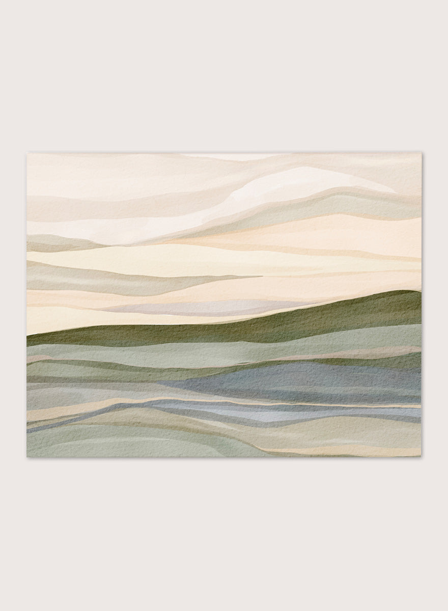 Framed abstract landscape wall art featuring layered hills and mountains in soft beige, cream, sage green, and muted blue tones. Shop Serene Rolling Hills by Nikita Jariwala, an abstract landscape wall art print poster featuring layered hills, distant mountains, and soft green tones.