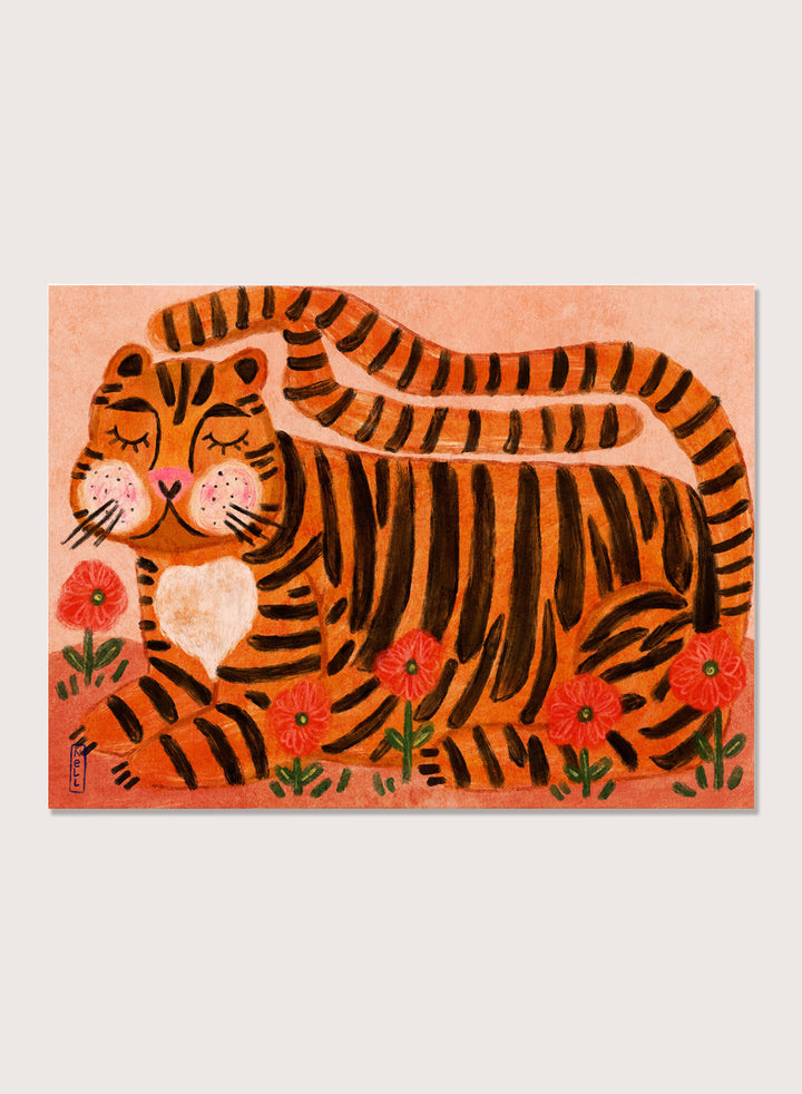 A framed art print featuring a stylized orange and black striped tiger lying among red flowers on a peach background. Playful tiger animal art print by Dirkie Nell with bold orange stripes, red poppies, and a warm peach background. Shop this cheerful piece today.