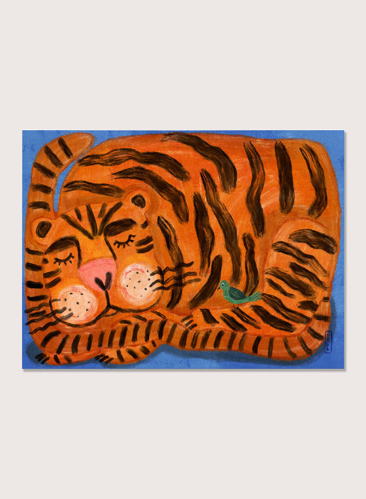 A framed painting of a sleeping tiger on a blue background. The tiger is orange with bold black stripes, has a pink nose and cheeks, and a small green bird near its side. A framed painting of a sleeping tiger on a blue background. The tiger is orange with bold black stripes, has a pink nose and cheeks, and a small green bird near its side. 
