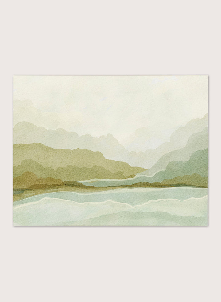 Shop Watercolor Mountain Valley Landscape by Nikita Jariwala, a mountain wall art print poster with soft green hills, blue water, and a muted watercolor palette.