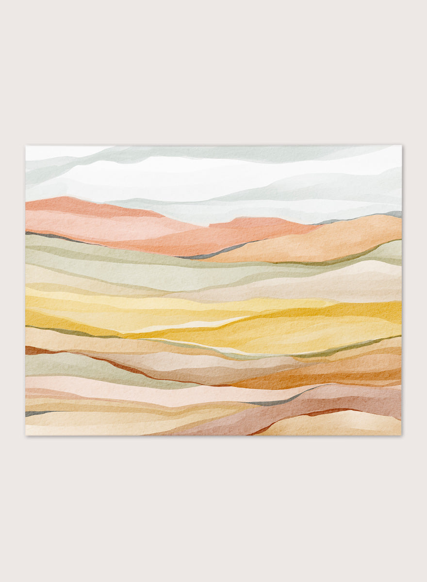 Framed abstract landscape wall art featuring layered wavy hills in soft peach, yellow, beige, and muted green tones. Shop Warm Horizon Layers by Nikita Jariwala, an abstract landscape wall art print poster with layered hills and mountains, soft yellow fields, and warm peach tones.