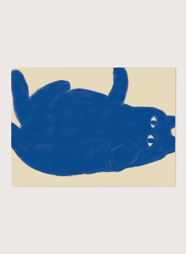 A framed art print featuring a bold blue abstract cat illustration on a warm beige background. Whimsical Blue Cat by The Art Concept is a playful cat art print featuring a lounging blue cat on a warm cream background in a bold minimalist style.
