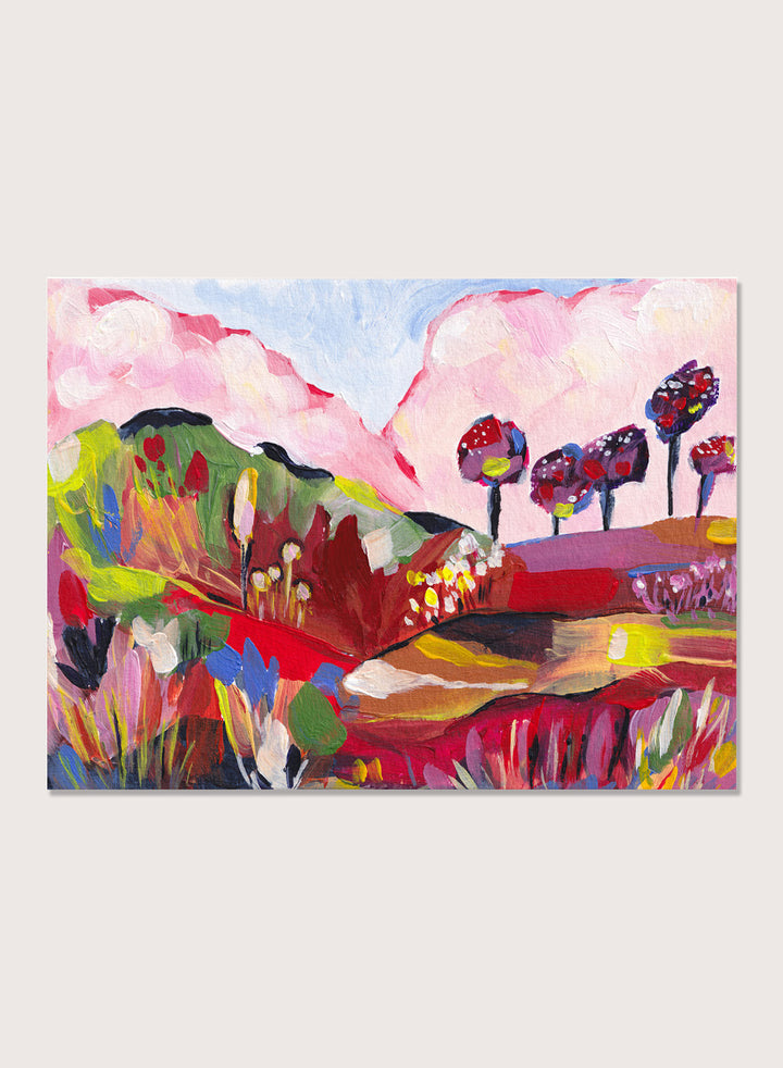 A framed abstract landscape painting featuring pink clouds, green hills, and colorful stylized trees. Shop Vibrant Fantasy Landscape by Dirkie Nell, a colorful landscape art print featuring pink clouds, rolling hills, wildflowers, and bold abstract color.