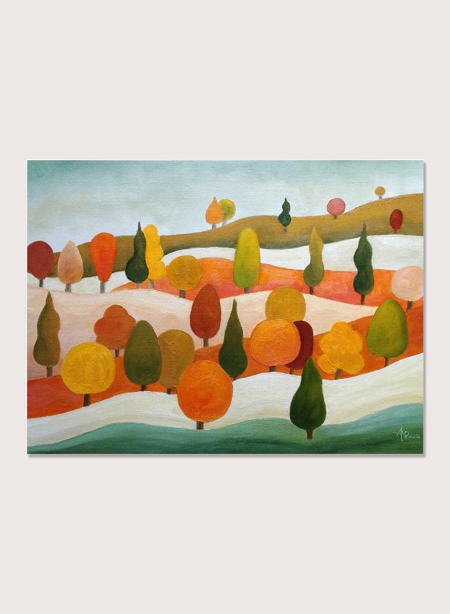 A framed landscape art print featuring stylized trees in autumn colors on rolling hills under a pale sky. Shop Colorful Autumn Hills by Angeles M. Pomata, an autumn landscape art print featuring rolling hills, stylized trees, and warm fall color.