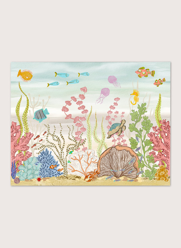 A framed art print depicting a colorful underwater scene with fish, coral, sea plants, a turtle, and a clam shell on a sandy ocean floor, shown against a light neutral background. Shop Vibrant Underwater World by Nikita Jariwala, an ocean wall art print poster with sea turtles, tropical fish, coral reef art, jellyfish, and blue tones.