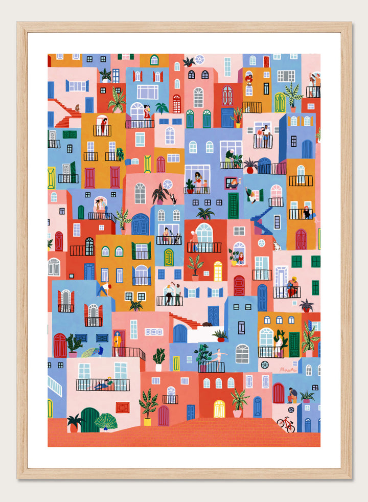 A framed art print featuring a colorful, whimsical illustration of Mediterranean-style buildings with people, animals, and plants. Colorful Town Life by Ceyda Alasar city art print featuring vibrant buildings, balconies, neighbors, plants, and lively urban details in bold color.
