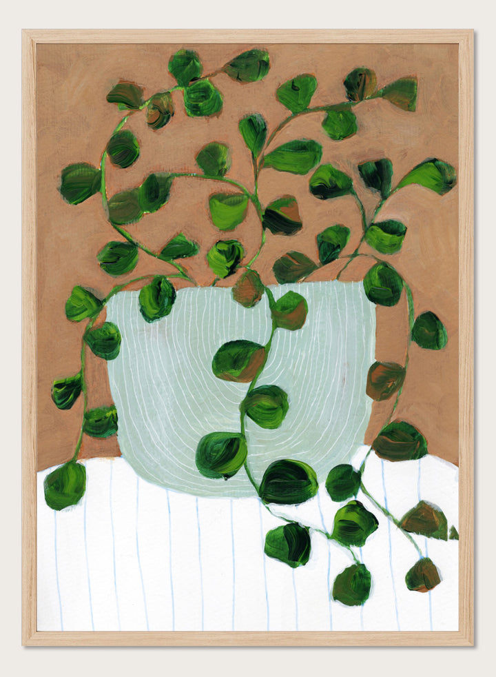 Shop Warm Houseplant Pot by Nikita Jariwala, a botanical wall art print poster featuring a trailing houseplant in a green pot with warm green tones.