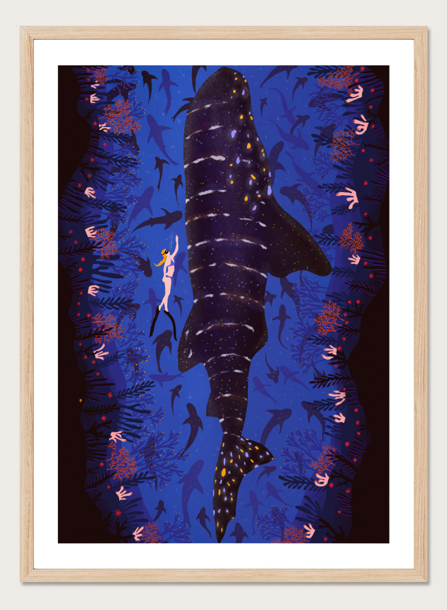 An illustrated art print featuring a large whale shark swimming through a deep blue ocean filled with smaller fish and coral. Diver and Whale Shark art print by Ceyda Alasar features a dramatic underwater view with a whale shark, diver, coral, and rich ocean blues.