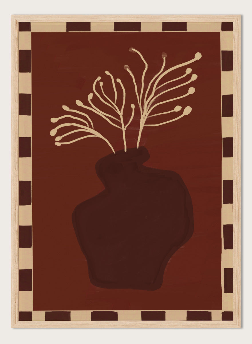 An art print featuring a dark brown abstract vase with cream branching stems on a deep reddish-brown background, framed by a beige and dark brown checkered border. Minimalist Vase Plant by The Art Concept still life art print featuring a dark vase, cream stems, checkerboard border, and warm rust-brown tones.