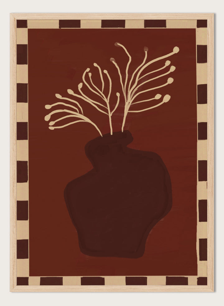An art print featuring a dark brown abstract vase with cream branching stems on a deep reddish-brown background, framed by a beige and dark brown checkered border. Minimalist Vase Plant by The Art Concept still life art print featuring a dark vase, cream stems, checkerboard border, and warm rust-brown tones.