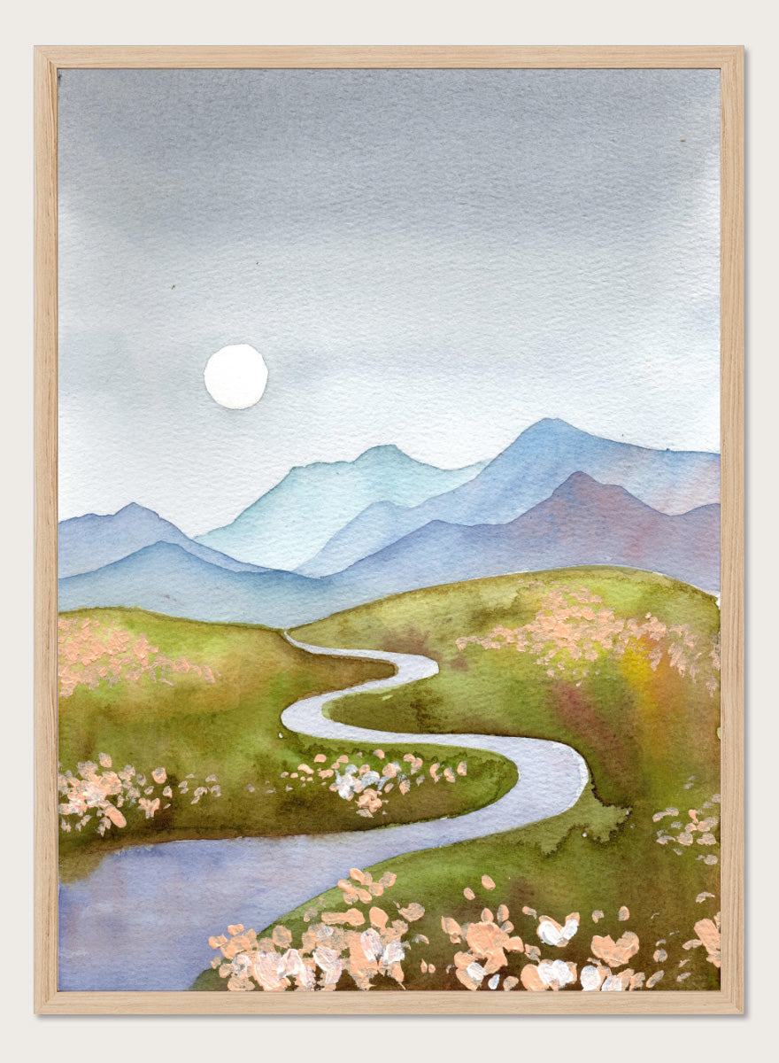 Watercolor landscape painting of a winding river flowing through green hills with pink flowers, blue mountains in the background, and a white sun in a gray sky. Shop Serene Mountain Path by Ekaterina Prisich, a landscape art print featuring a winding valley path, blue mountains, soft flowers, and a white moon.