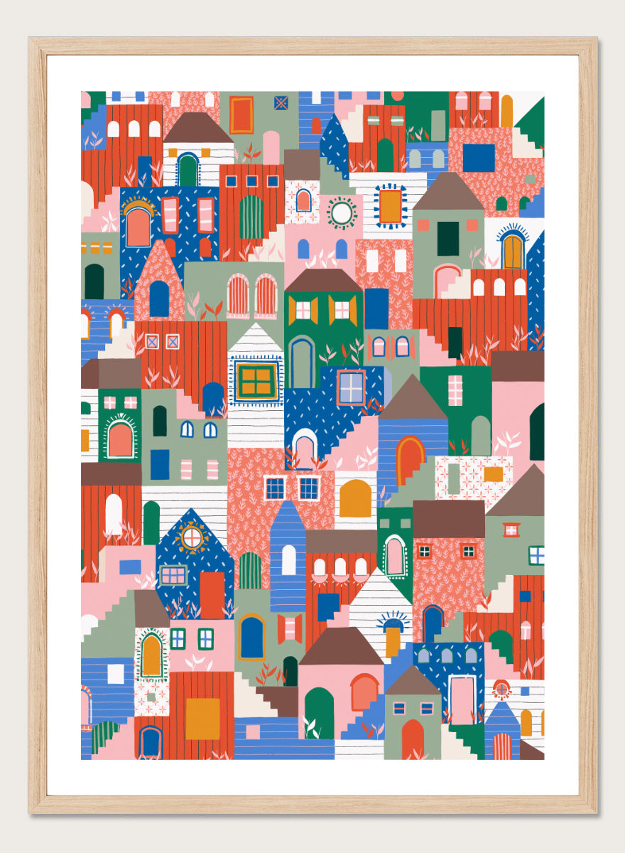 A colorful art print featuring a dense, stylized illustration of houses and buildings in a playful, patterned village scene. Whimsical Cityscape Charm by Ceyda Alasar city art print featuring stacked colorful houses, patterned walls, winding stairs, and playful architectural details.