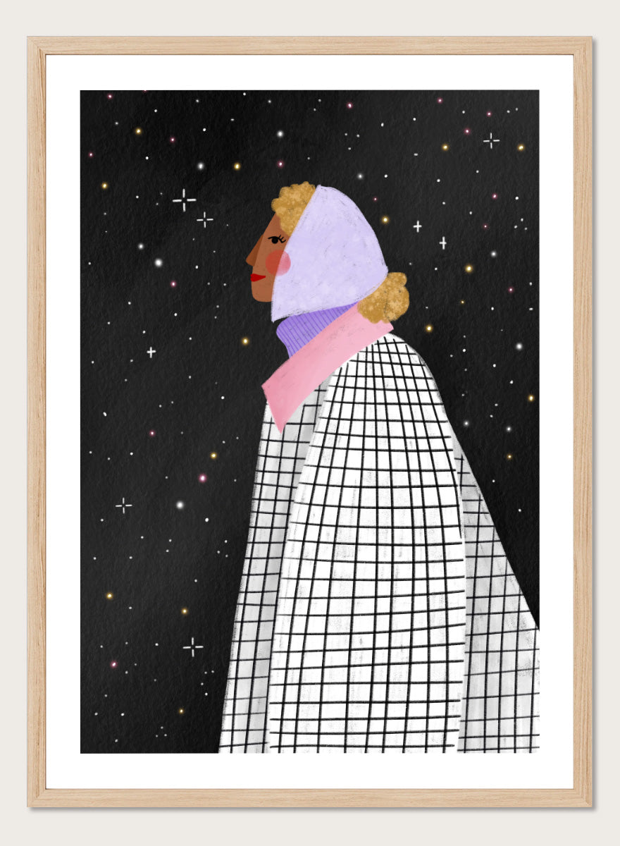 A framed art print featuring a stylized illustration of a woman in profile wearing a white and black checkered cape and a lavender headscarf against a black starry background. Shop Woman Under Starry Night by Bea Müller, a figurative wall art print poster featuring a contemplative woman beneath a star-filled black night sky.