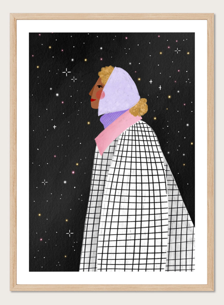 A framed art print featuring a stylized illustration of a woman in profile wearing a white and black checkered cape and a lavender headscarf against a black starry background. Shop Woman Under Starry Night by Bea Müller, a figurative wall art print poster featuring a contemplative woman beneath a star-filled black night sky.