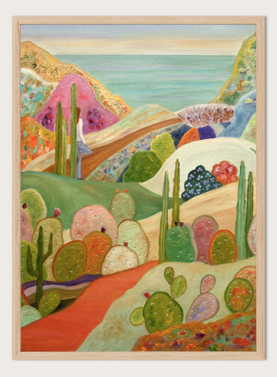 A colorful landscape painting featuring stylized cacti and succulents in a desert valley, with rolling hills, a pink mountain, and a blue sea or sky in the background. Shop Colorful Desert Yoga View by Angeles M. Pomata, a colorful desert landscape art print featuring cacti, rolling hills, a yoga figure, and coastal views.