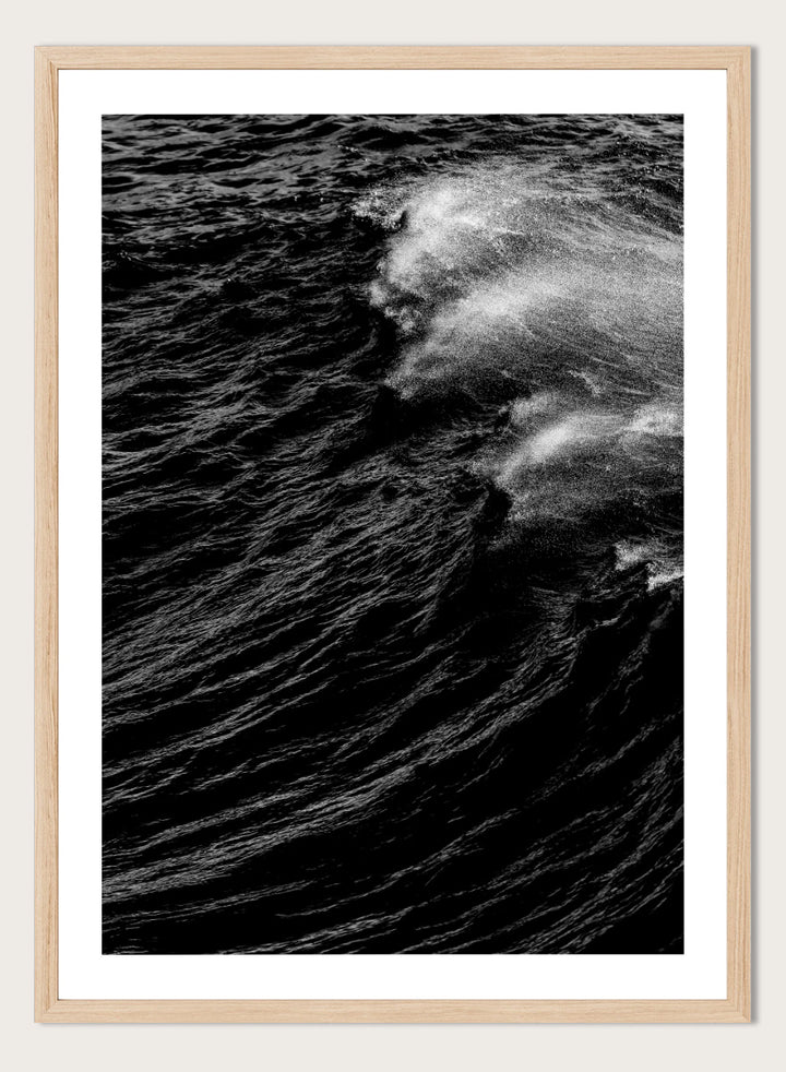 Black and white fine art photographic print of a crashing ocean wave. Dark Wave Symphony by Shot by Clint black-and-white ocean photography print featuring breaking waves, sea spray, and dramatic water texture.