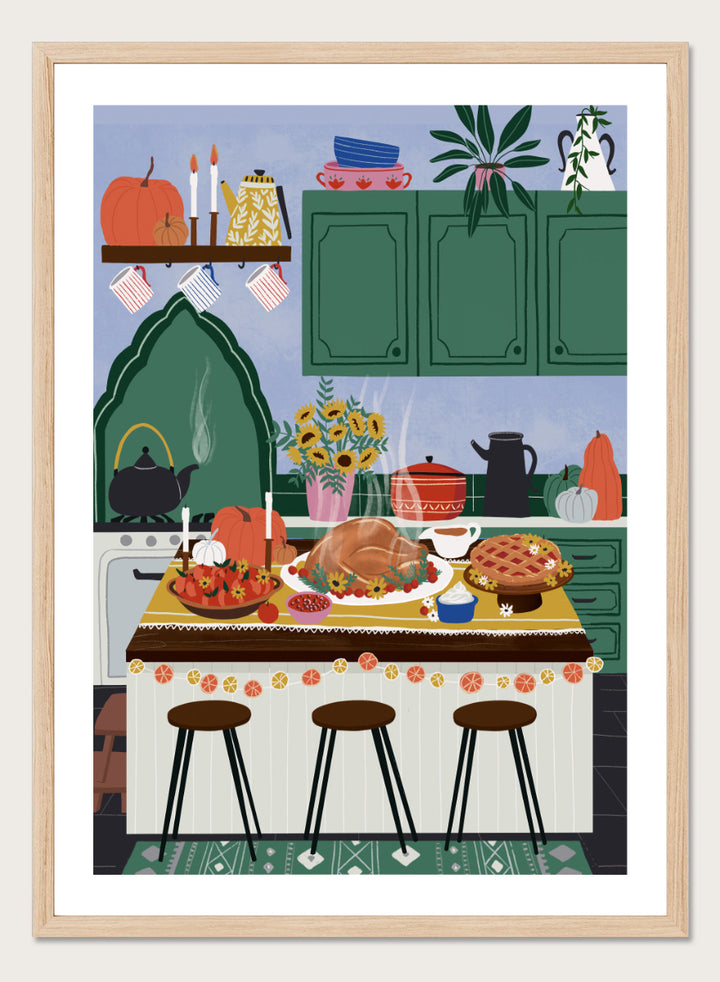 A framed art print depicting a cozy, stylized autumn kitchen scene with a large roasted turkey on a table covered in fall dishes, green cabinets, pumpkins, and three bar stools. Cozy Thanksgiving Kitchen by Ceyda Alasar kitchen art print featuring a turkey feast, pie, pumpkins, flowers, candles, and warm autumn decor.