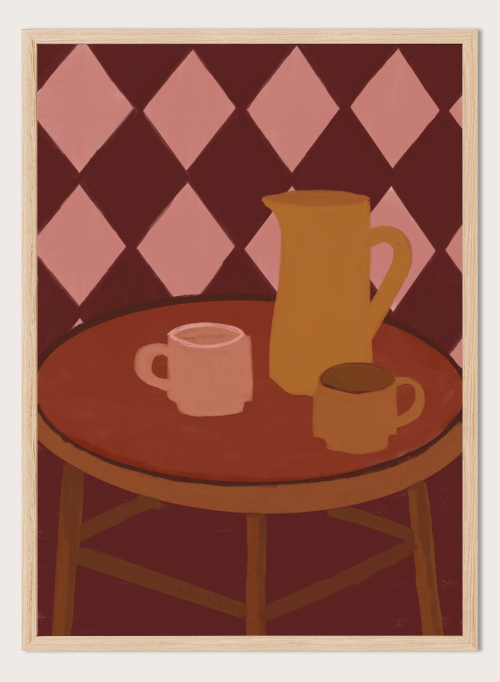 A stylized illustration of a round wooden table with a pink mug, a yellow pitcher, and a small cup against a dark red and pink diamond-patterned background. Retro Coffee Time by The Art Concept warm art print featuring mugs, a pitcher, and a café table in soft retro tones and a diamond pattern background.