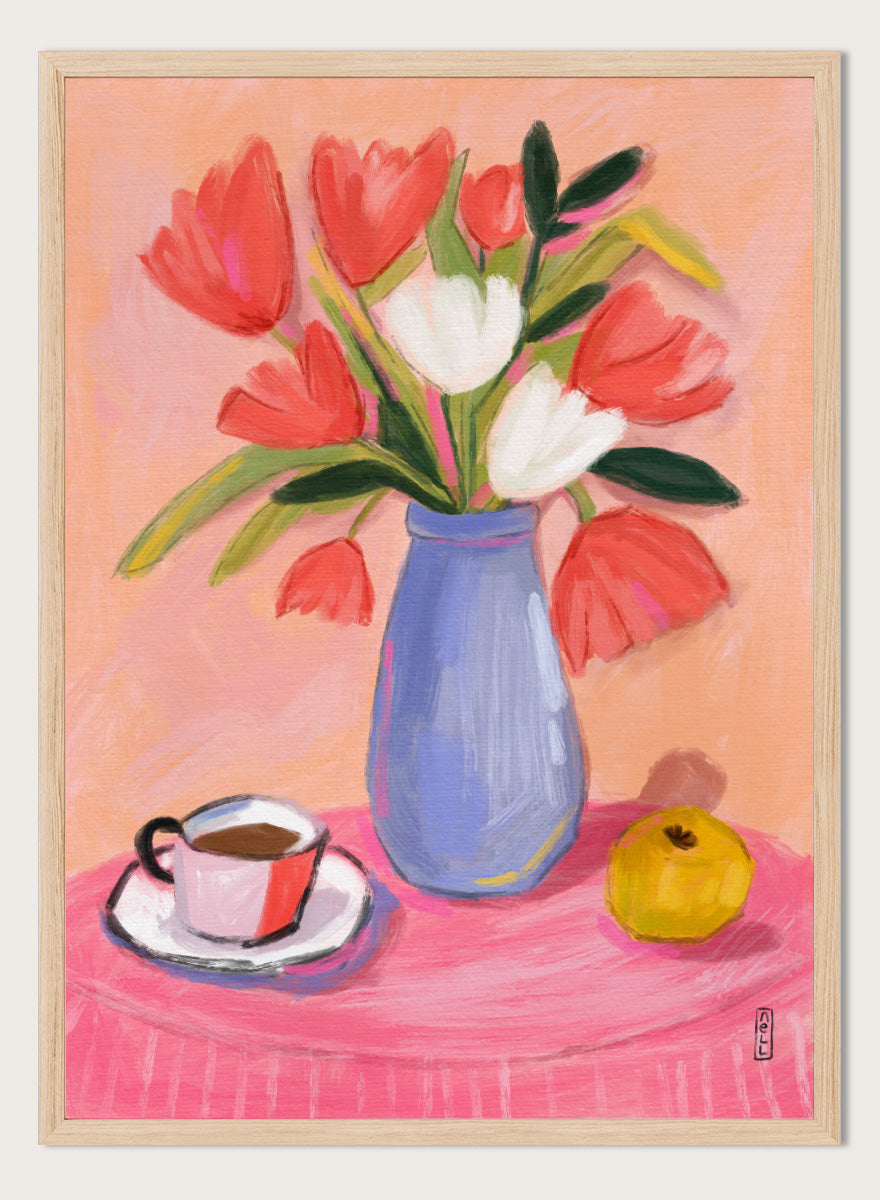 A still life painting of a bouquet of red and white tulips in a blue vase, set on a pink tablecloth next to a cup of coffee and a yellow fruit, against a peach background. Shop Fresh Tulips and Coffee by Dirkie Nell, a colorful floral still life art print featuring tulips, coffee, a blue vase, and warm pink and peach tones.