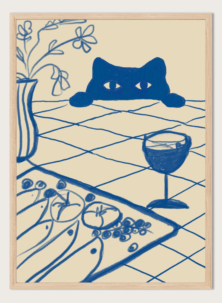 A stylized blue line-art illustration of a cat peeking over a table with a wine glass, flowers, and food, rendered in a cream background. Curious Blue Cat Dinner by The Art Concept is a playful cat art print featuring a peeking blue cat, table setting, flowers, and bold linework.
