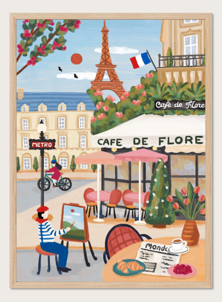 A colorful illustrated Paris street scene with the Eiffel Tower, a cafe exterior labeled Cafe de Flore, a cyclist, a seated painter, flowers, and a French flag. Shop Paris Cafe Life by Nidhi Kachhadiya, a colorful Paris wall art print inspired by French café culture, the Eiffel Tower, and charming European city life.