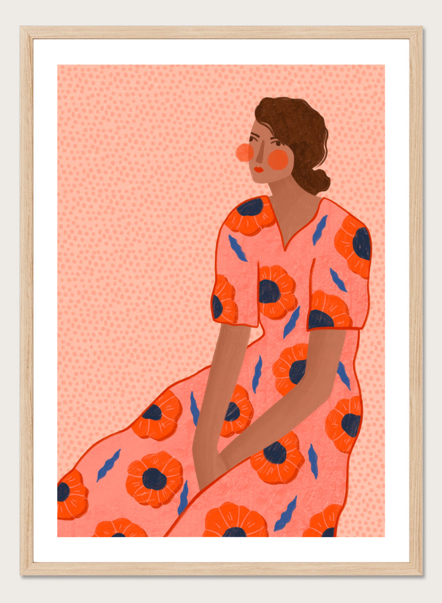 A stylized fashion illustration of a seated woman in a coral pink dress with large orange poppy motifs and blue leaf accents, shown with a white border and black frame. Stylish Poppy Portrait by Bea Müller floral woman art print featuring a pink dress covered in orange poppies and blue leaves for colorful modern wall decor.