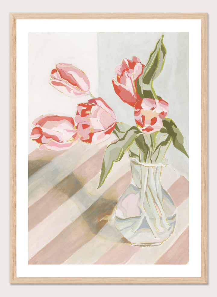 Artistic depiction of pink tulips in a clear vase on a striped background. Tulips in a Vase by Lucrecia Caporale is an officially licensed still life art print featuring pink tulips in a glass vase. Available framed or unframed.